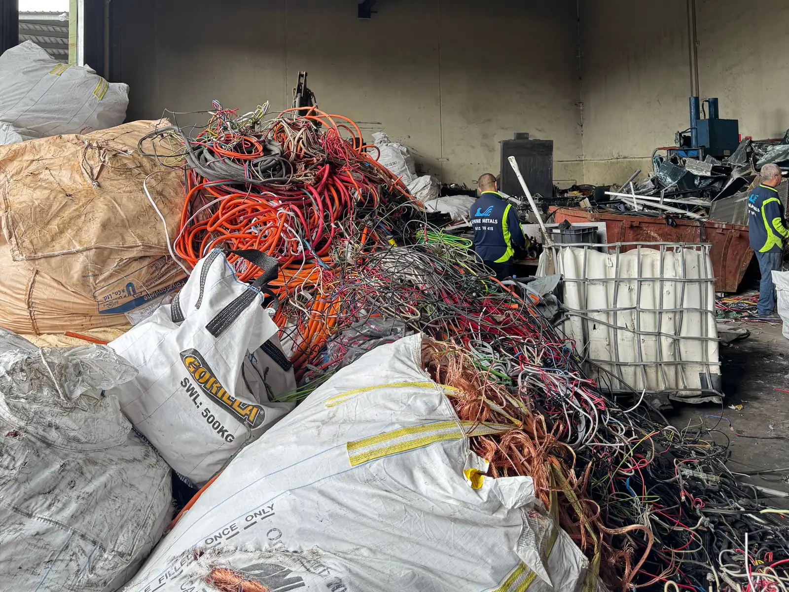 Staff sorting cable among bulka bags inside the shed at the Ingleburn yard